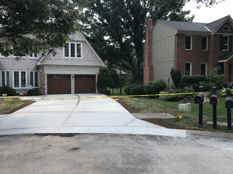 Finished poured concrete driveway in front of a home