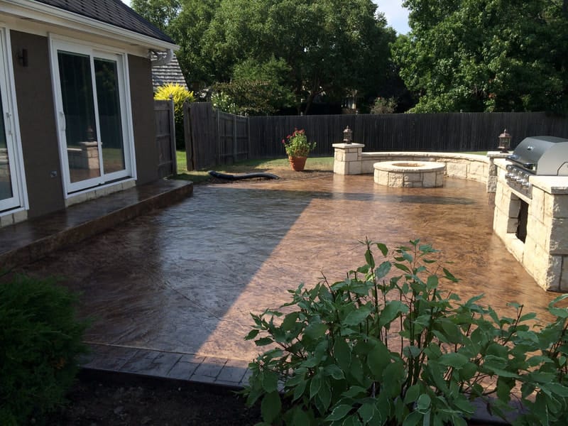 Stamped concrete patio with a seating wall and built-in grill station