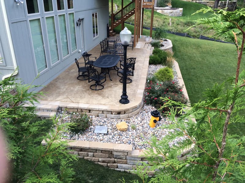 Raised stamped concrete patio with an outdoor dining set