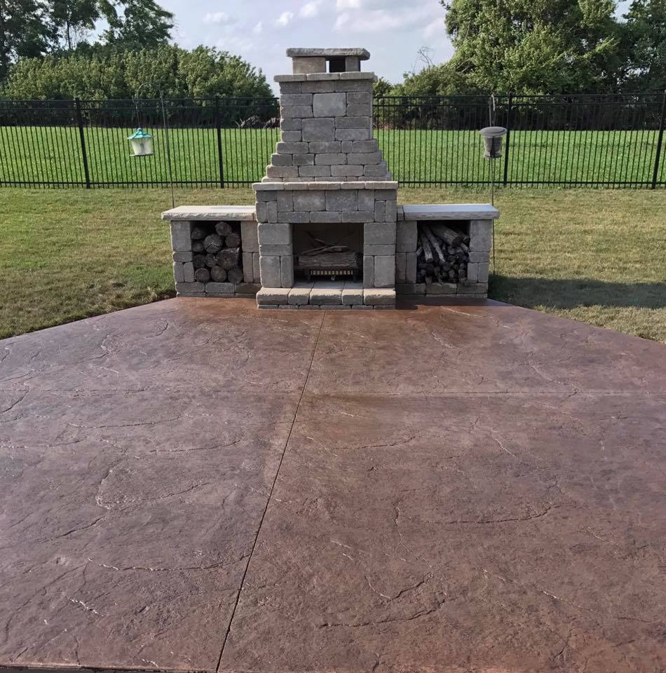 Outdoor fireplace on a stamped concrete patio