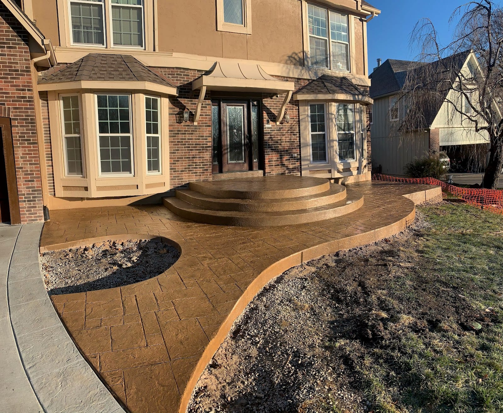 Decorative stamped concrete walkway and steps at a home entrance