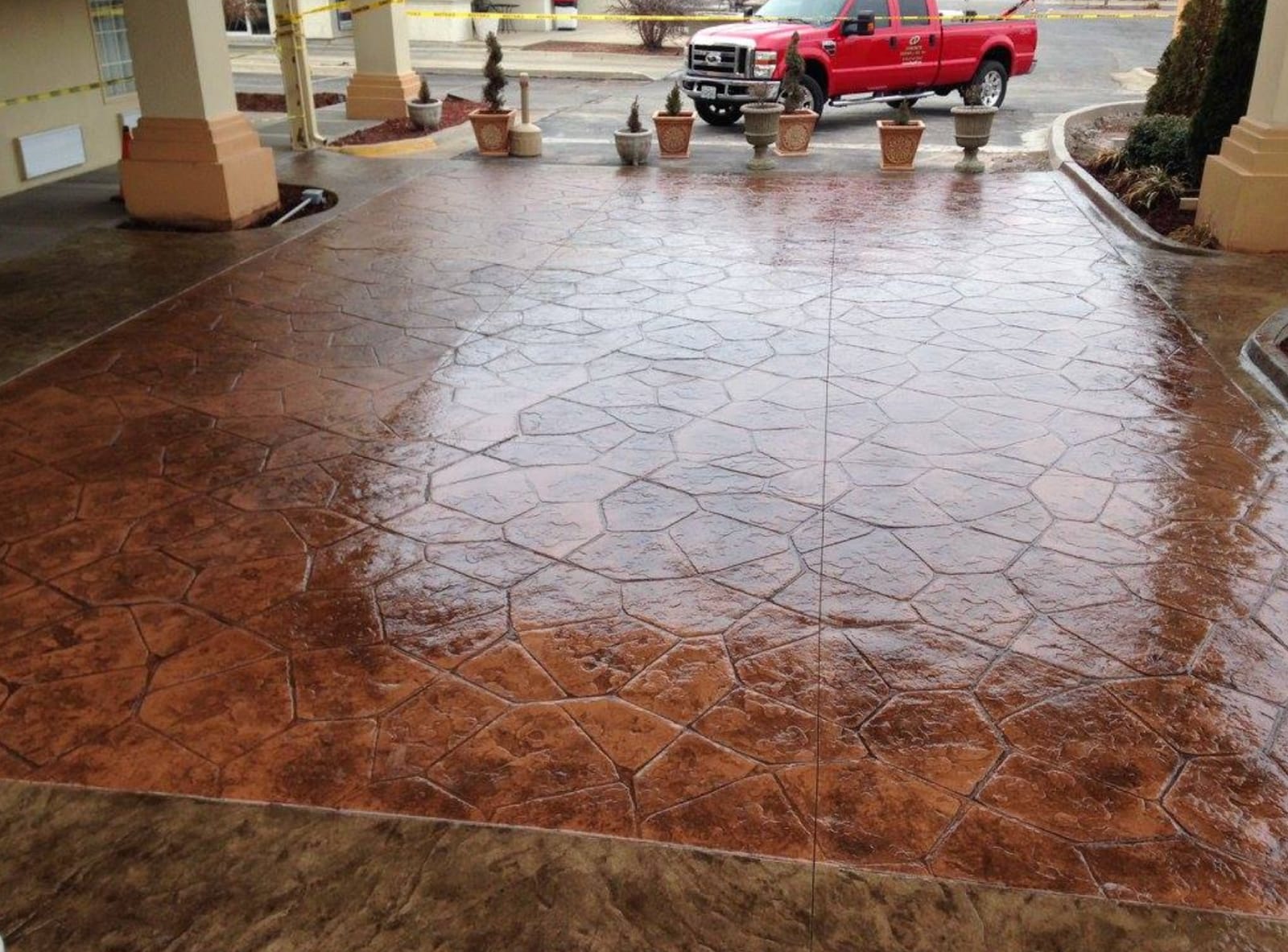 Large stamped concrete patio behind a home